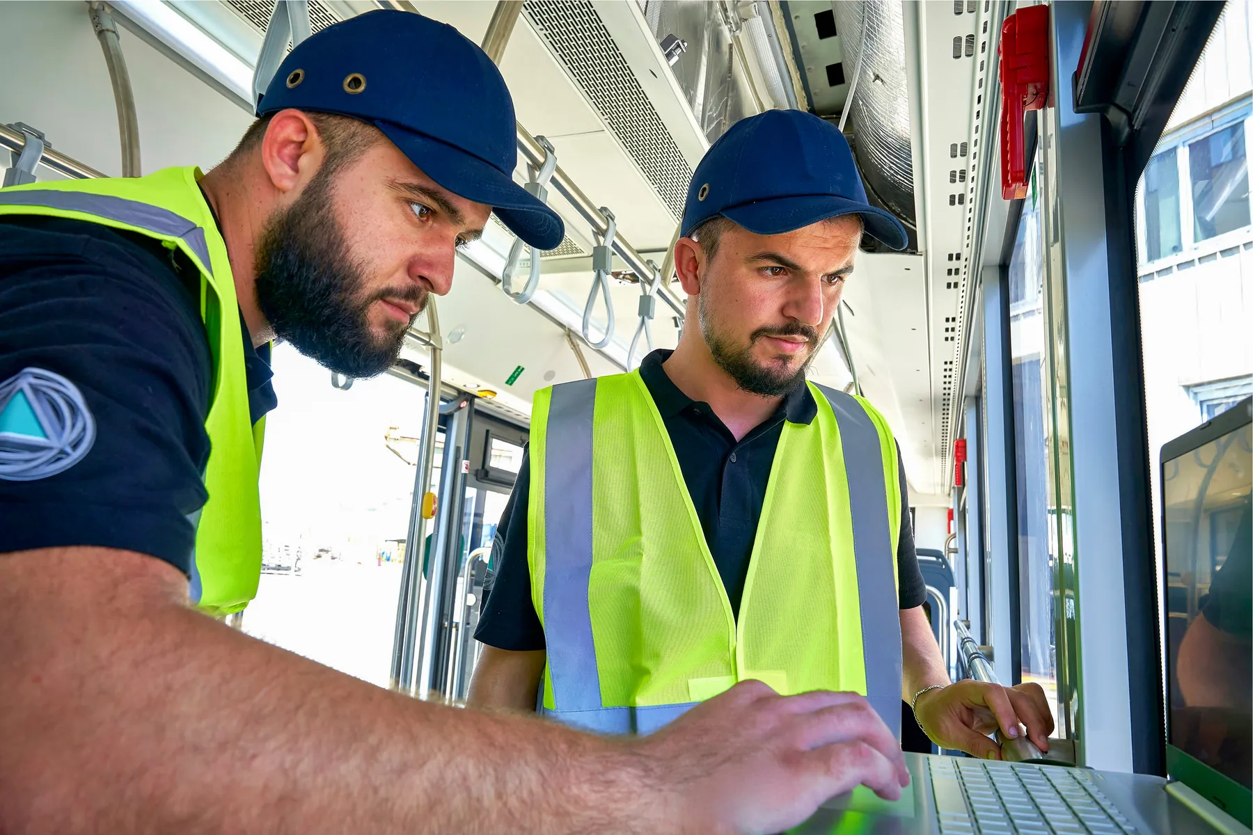 YES-EU technicians using a laptop inside an electric bus